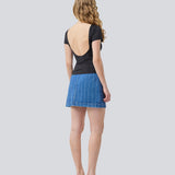 Denim short skirt in cotton denim. IsoldeMD jacquard skirt has an asymmetrical closure in front and is closed with a button.
