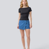 Denim short skirt in cotton denim. IsoldeMD jacquard skirt has an asymmetrical closure in front and is closed with a button.