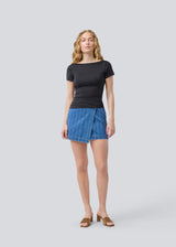 Denim short skirt in cotton denim. IsoldeMD jacquard skirt has an asymmetrical closure in front and is closed with a button.