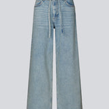 Jeans with wide legs in cotton denim in a light blue wash. IsoldeMD pants have a high waist, front and back pockets and a tie band at the waist.