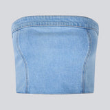 Short denim top in a corset design. IvannaMD top in made in light colored denim and is closed with a zipper at the back.