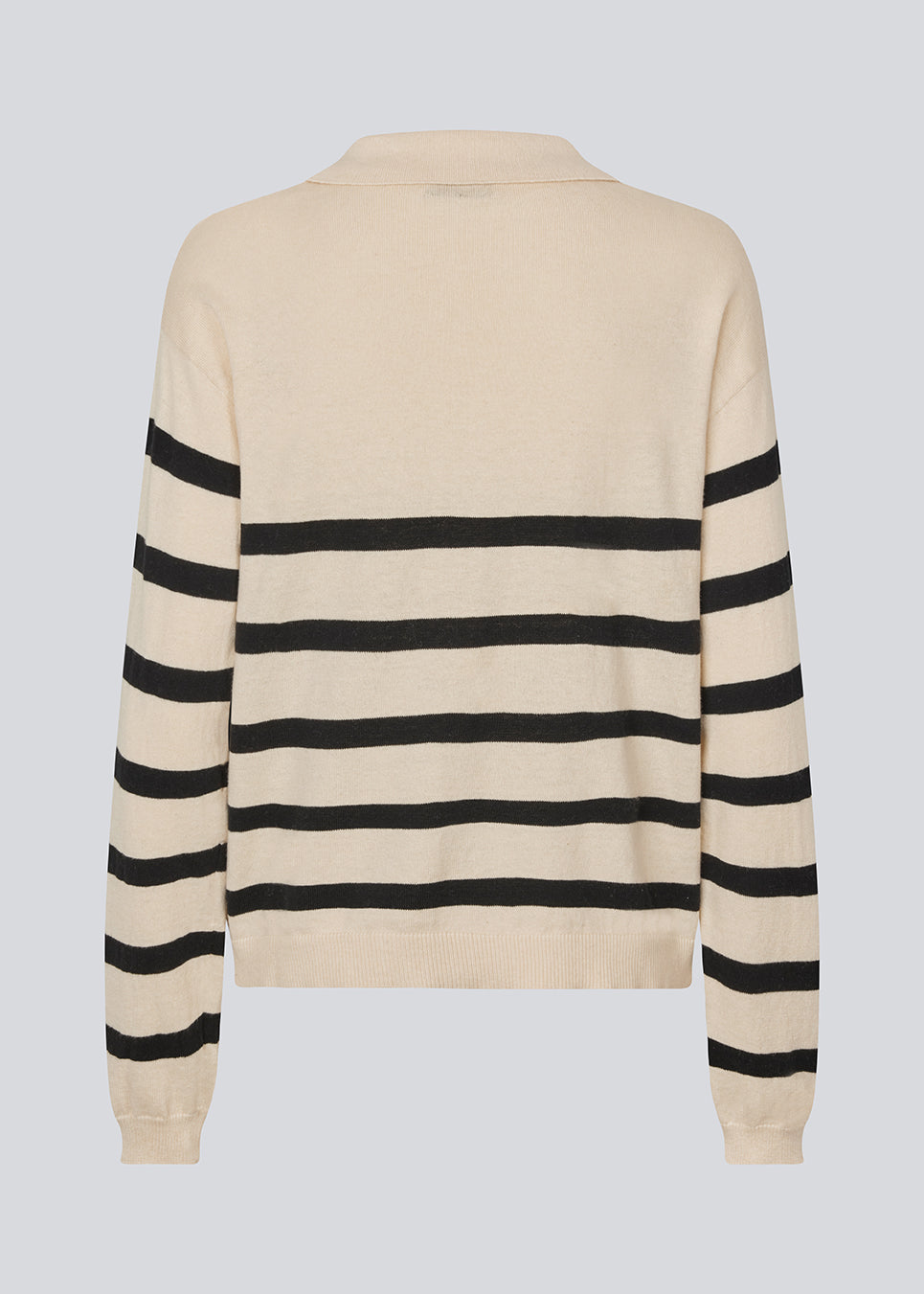 Soft knit/blouse with a v-neckline and a shirt collar. IvoryMD v-neck has ribbed edges at the bottom and sleeves. The knit is beige with black stripes.&nbsp;