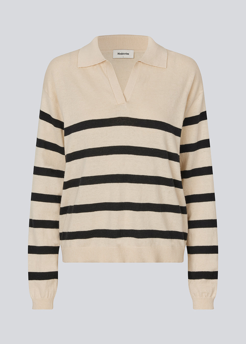 Soft knit/blouse with a v-neckline and a shirt collar. IvoryMD v-neck has ribbed edges at the bottom and sleeves. The knit is beige with black stripes.&nbsp;
