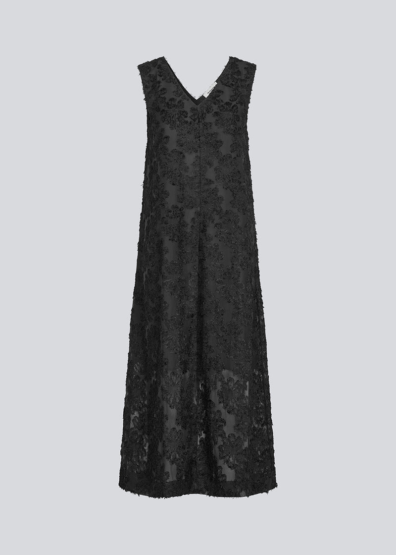 Sleeveless black dress in a slightly see-through material with lining. IvyMD dress has a loose fit and a V-neckline.