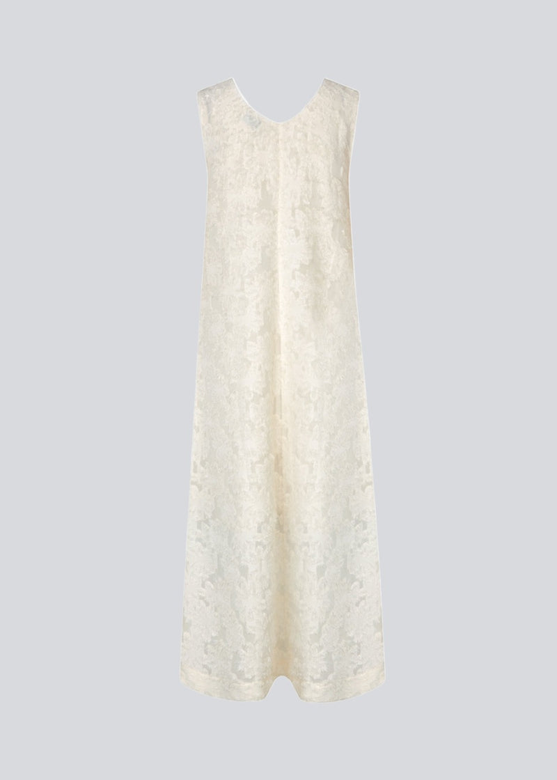 Sleeveless beige dress in a slightly see-through material with lining. IvyMD dress has a loose fit and a V-neckline.