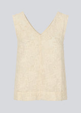 Sleeveless top in creme in a slightly see through material with lining. IvyMD top has a loose fit and a V-neckline.