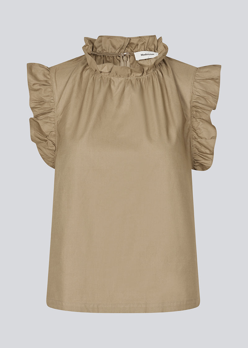 Loose top in light brown with a ruffle detail at the sleeves and neck. IzakMD top is sleeveless and has a hidden zipper in the back.&nbsp;