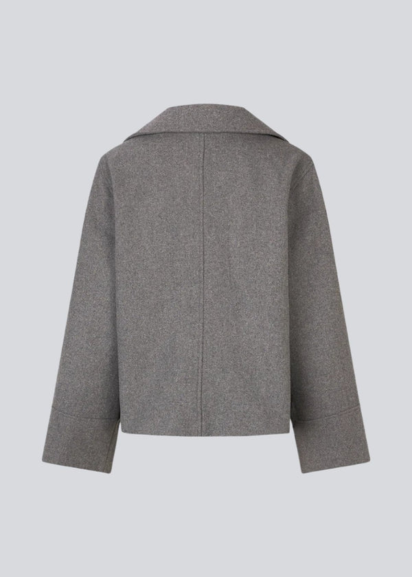 Grey jacket with a loose fit and wide sleeves in a wool mix. JannaMD jacket has two pockets in front, collar and a zipper closure in the side.