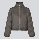 Slightly cropped brown puffer with a high neck. JoniMD jacket has side pockets, elastic at the sleeves and an adjustable string at the hem.