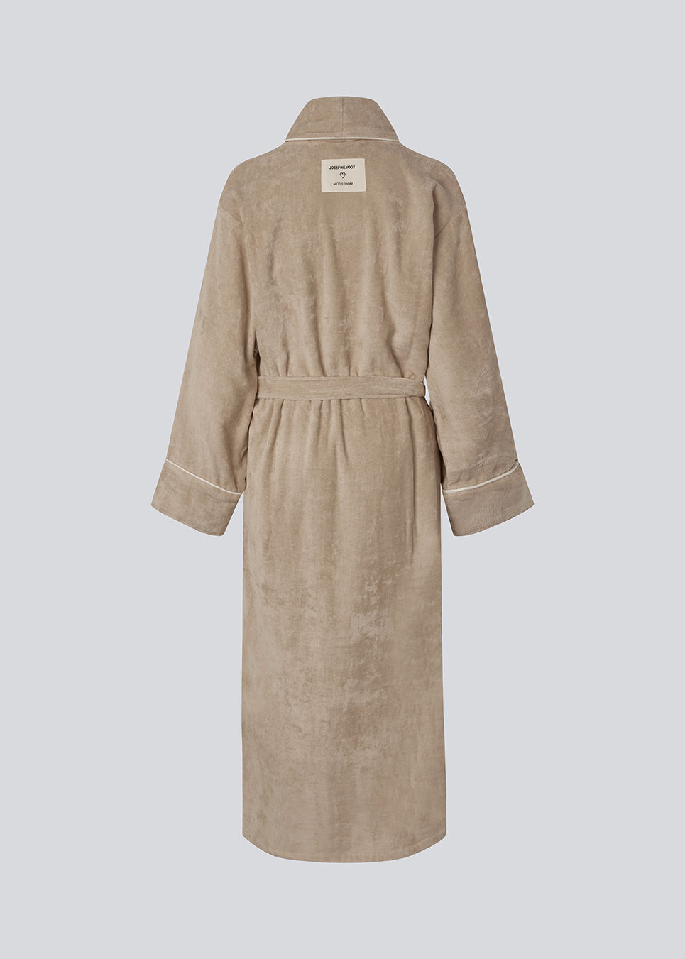 Beige oversized bathrobe. Josefinemd bathrobe is made from 100% organic cotton. It features large pockets, a belt, and contrast trims for an elegant touch. Finished with a subtle logo on the back – ideal for cozy mornings.&nbsp; Josefine Vogt (165 cm) and the model (177 cm) are both wearing size Small.