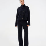 Josefine Vogt – high-neck cardigan. The Josefinemd knit cardigan features a cable-knit design with a high collar, buttoned cuffs, and front pockets. Timeless and perfect for chilly days, or as a layering piece over dresses and tops.