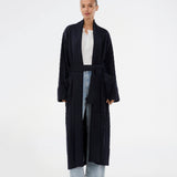 Blue cable-knit long cardigan. The Josefinemd robe is a long cardigan featuring pockets and a tie belt. Perfect for cozy mornings and chilly winter days.&nbsp;Josefine Vogt (165 cm) and the model (177 cm) are both wearing size Small.