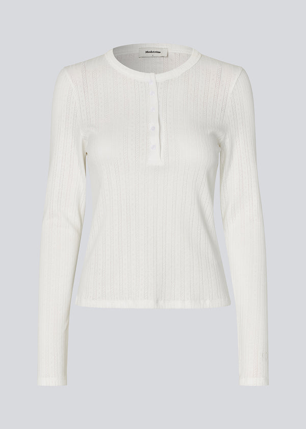 White fitted long-sleeve pointelle t-shirt. Josefinemd LS t-shirt is crafted in pointelle cotton with lace trim. The feminine cut and subtle openwork pattern give this classic style an elegant touch. Josefine Vogt (165 cm) and the model (177 cm) are both wearing size Small.

Shop matching pants: Josefinemd pants&nbsp;