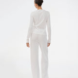 White pointelle pants. Josefinemd pants are feminine pointelle cotton trousers with lace trim and a subtle openwork pattern. Soft, comfortable, and ideal for relaxing at home. Josefine Vogt (165 cm) and the model (177 cm) are both wearing size Small.