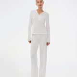 White pointelle pants. Josefinemd pants are feminine pointelle cotton trousers with lace trim and a subtle openwork pattern. Soft, comfortable, and ideal for relaxing at home. Josefine Vogt (165 cm) and the model (177 cm) are both wearing size Small.