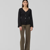 Flat knitted cardigan with a V-neck in black. KaitoMD cardigan is fitted and has long wide sleeves with a folded detail.