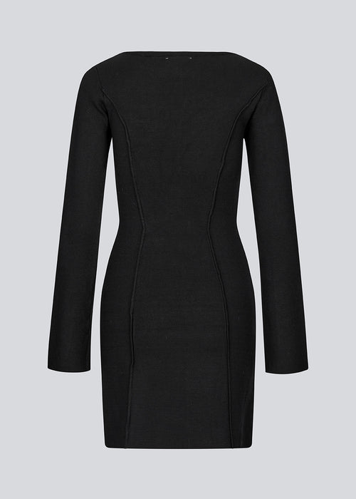 Short flat knitted dress with folded details in black. KaitoMD dress is fitted and has long wide sleeves.