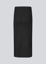 Long black flat knitted skirt with folded details. KaitoMD skirt has an elastic waistband and a slit in front.