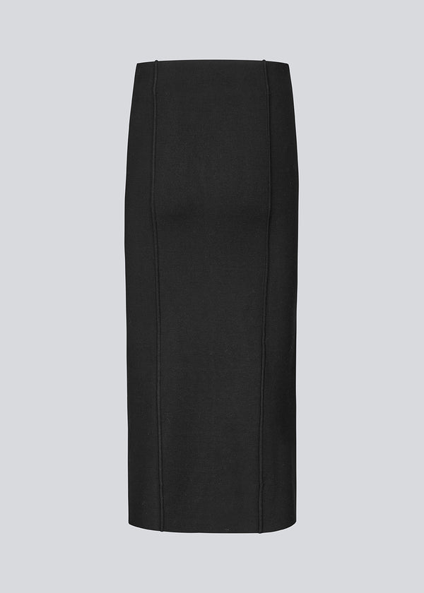 Long black flat knitted skirt with folded details. KaitoMD skirt has an elastic waistband and a slit in front.