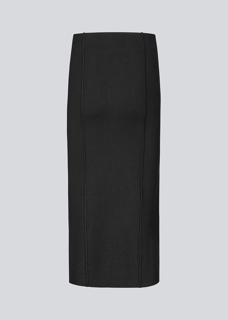 Long black flat knitted skirt with folded details. KaitoMD skirt has an elastic waistband and a slit in front.