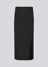 Long black flat knitted skirt with folded details. KaitoMD skirt has an elastic waistband and a slit in front.