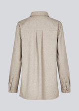 Beige long shirt with folded details in front. KalemMD shirt has two chest pockets, button closure in front and slits in the side seams.