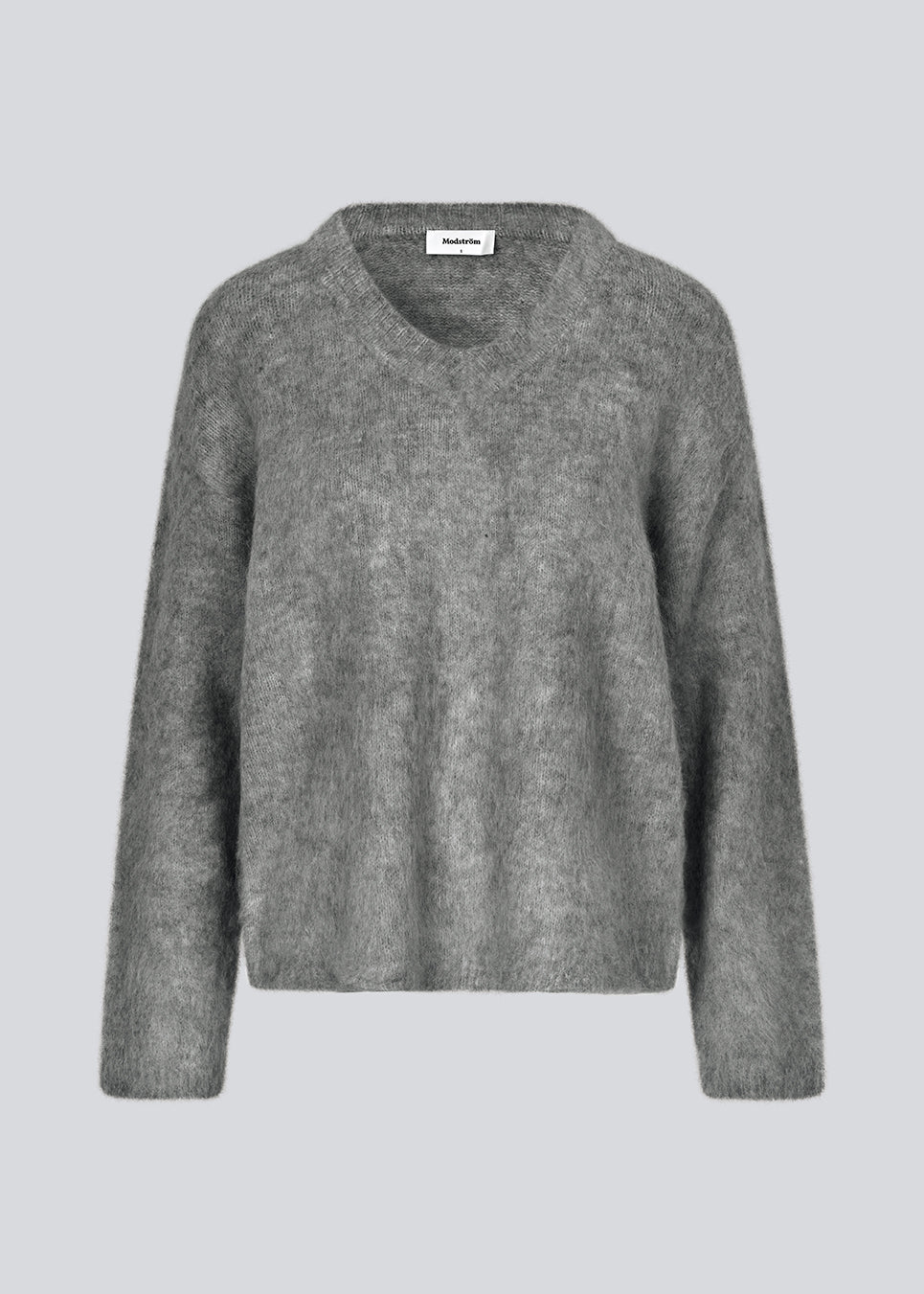 Soft knit in dark grey with a v-neck. KaneMD v-neck has a loose fit and dropped shoulders.