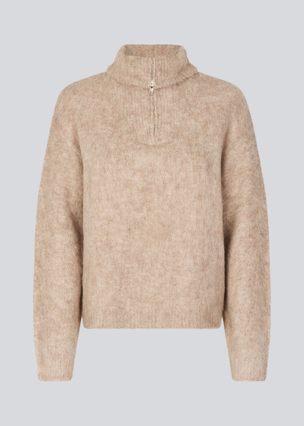 Soft beige knit with a high neck and half zip front. KaneMD v-neck has a loose fit and dropped shoulders.