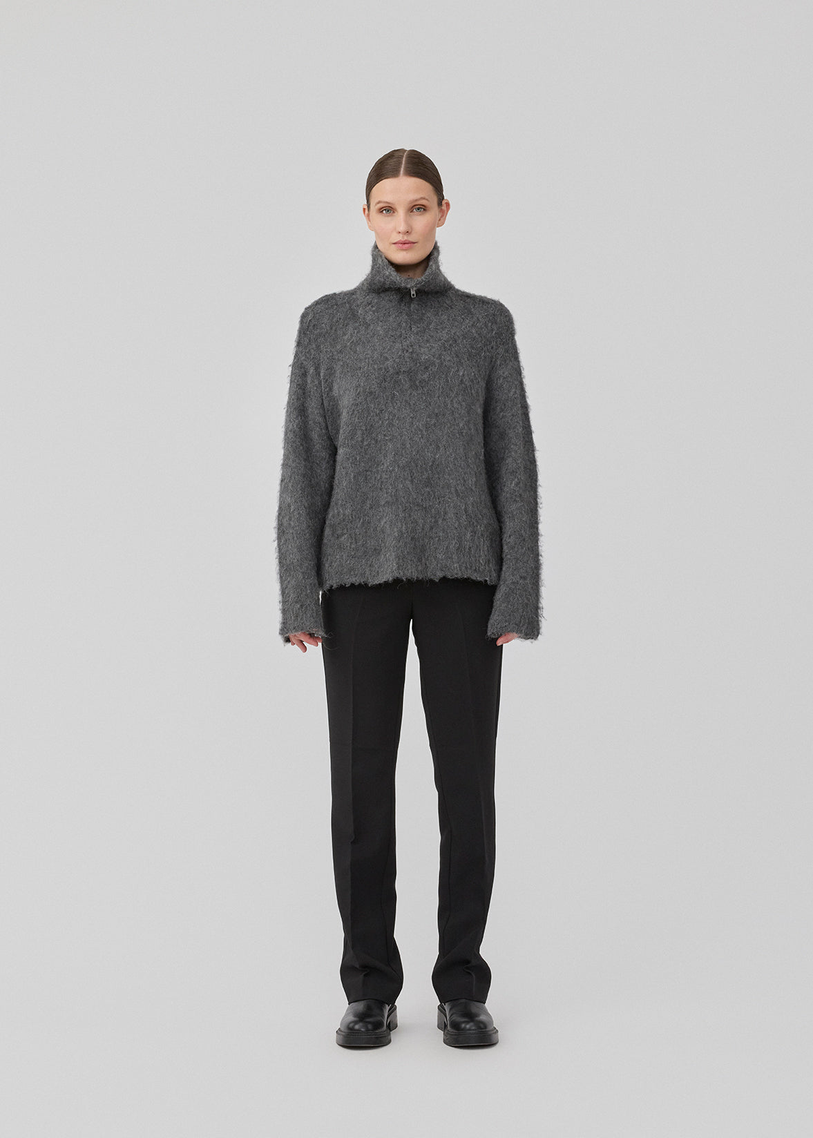 Soft grey knit with a high neck and half zip front. KaneMD v-neck has a loose fit and dropped shoulders.