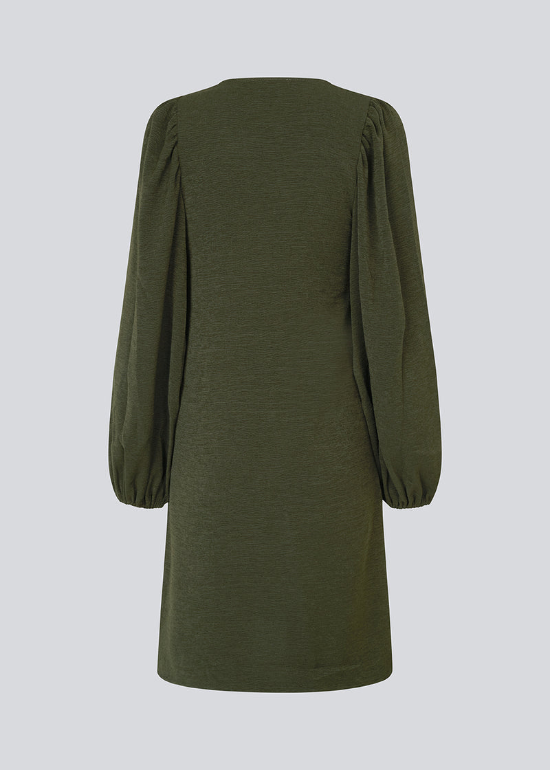 Dark green short dress in a light structured material. KarliMD short dress has puff sleeves and a V-neck.