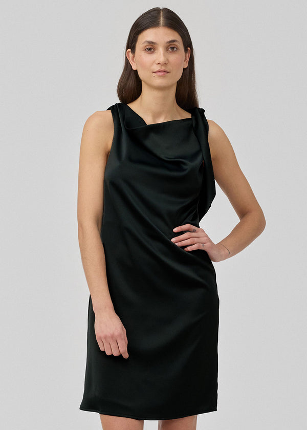 Midi satin dress with waterfall detail at the neck in black. KatjaMD dress has a tie detail at the shoulder and a relaxed fit.&nbsp;