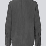 Long dark grey sleeved top with a hidden button closure in the back. KemmaMD top has loose sleeves and a cuff with button closure.