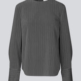Long dark grey sleeved top with a hidden button closure in the back. KemmaMD top has loose sleeves and a cuff with button closure.