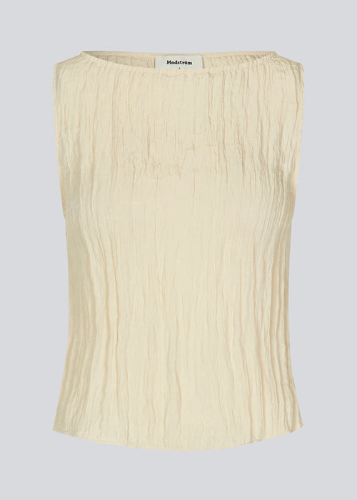 Sleeveless top in a structured material. KevinMD top in Summer Sand has a round neck and is slightly cropped.