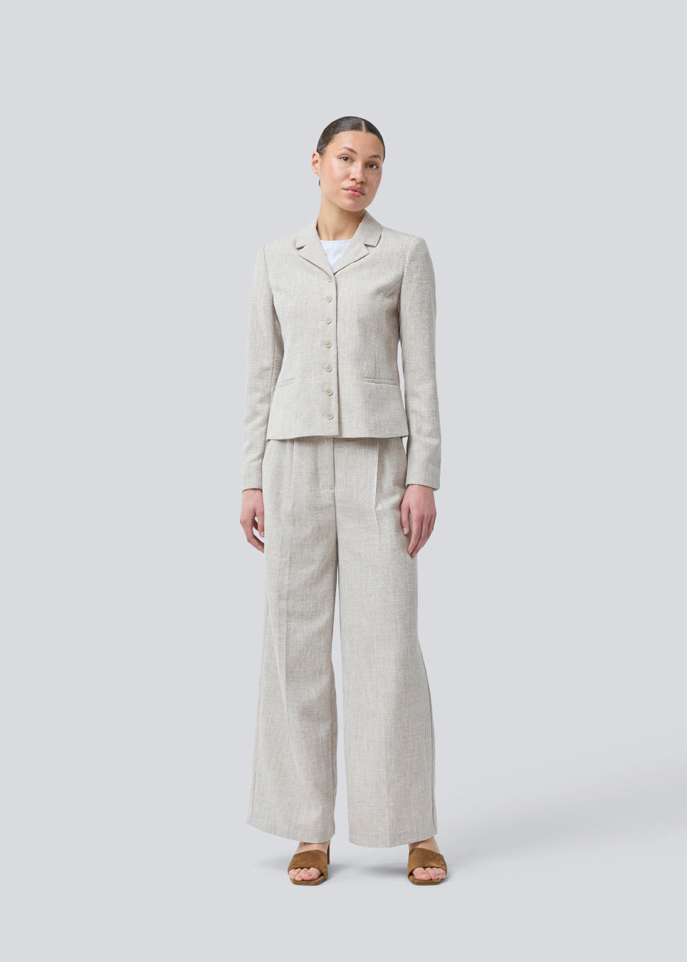 Our popular Kiera suit is back, now in a new summer color.
Suit pants in beige melange in a structured material with wide legs. KieraMD pants have a high waist, a zipper, side pockets, and paspoil pockets in the back.