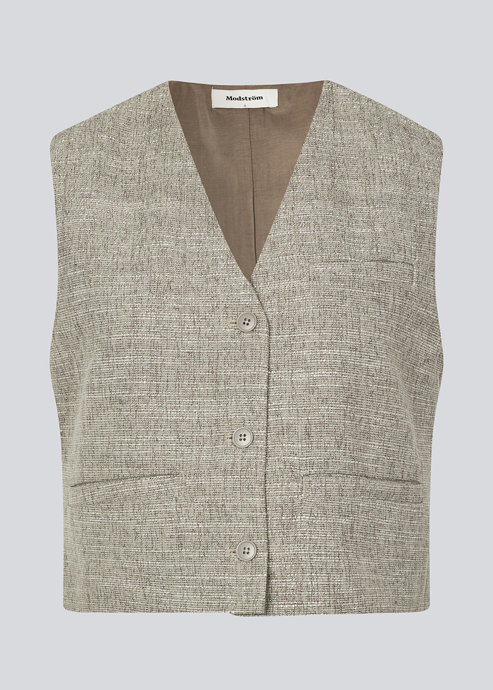 Suit vest in a structured material. KieraMD vest has a loose fit, 3 front pockets and lining.