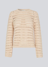 Slightly see through knit with a hole pattern. KolbyMD o-neck in color Summer Sand has a relaxed fit and loose sleeve.