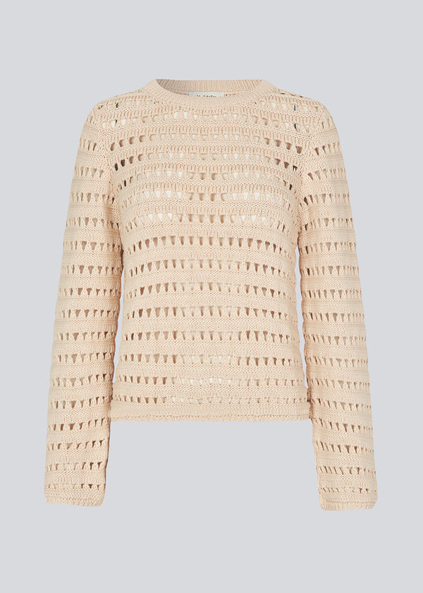 Slightly see through knit with a hole pattern. KolbyMD o-neck in color Summer Sand has a relaxed fit and loose sleeve.