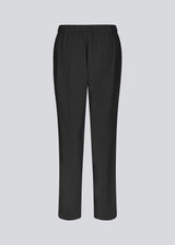 Loose black pants with a high waist. KollinMD pants have a fly, side pockets and elastic in the waist.