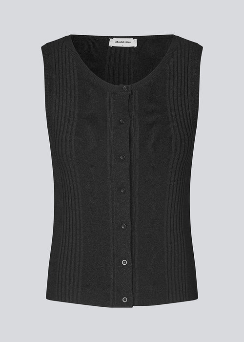 Sleeveless top in knit. KrissaMD top in Black has a round neck and a button closure in front.