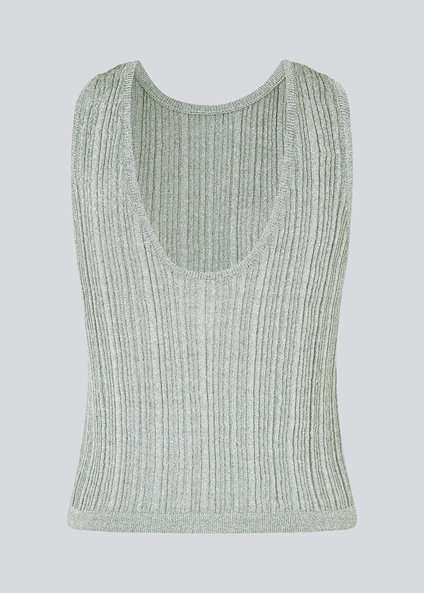 Sleeveless silver knitted top in a metallic material. KristenMD top has a loose fit, a round neck and a deep back neckline.