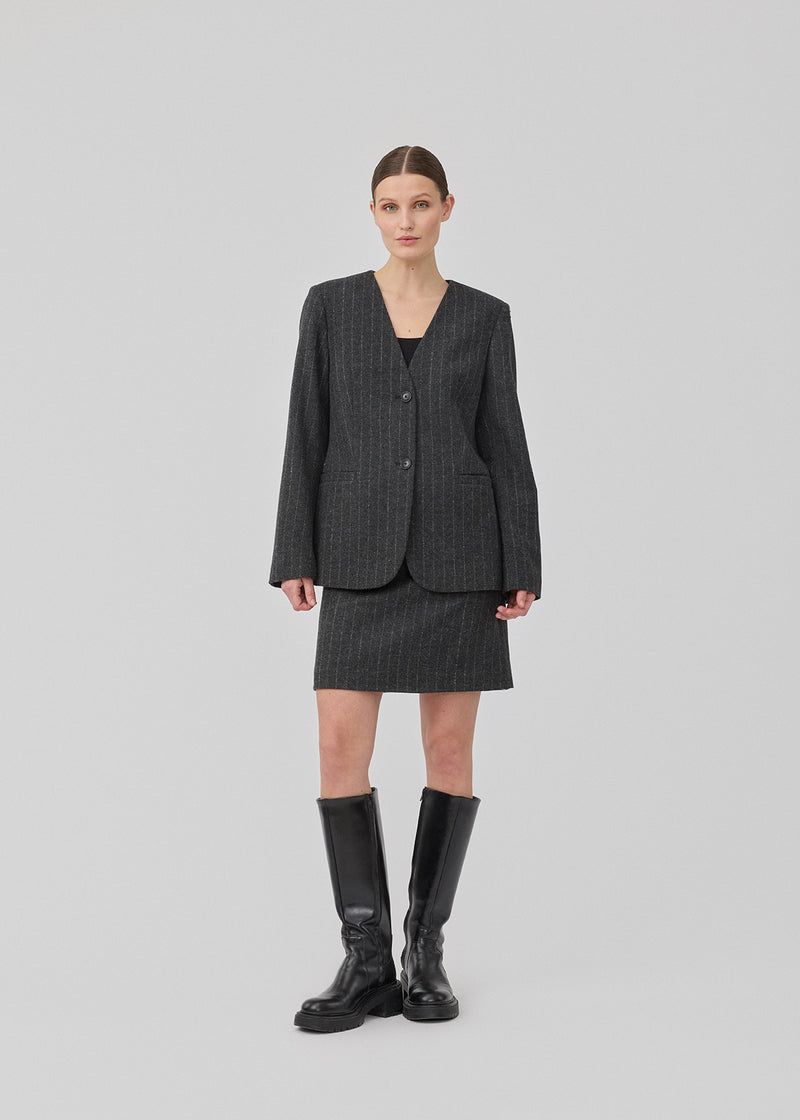 Short dark grey skirt in a pinstriped wool mix. KristolMD skirt has lining and an invisible zipper in the side.