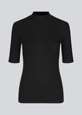 Short-sleeved black t-shirt with a high neck. Krown t-shirt is of a nice rib quality and has a tight fit. A must-have basic style in your wardrobe. 