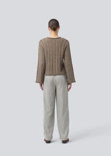 Loose knit with wide sleeves in cable knit. KurtisMD round neckline and rolled edges.