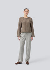 Loose knit with wide sleeves in cable knit. KurtisMD round neckline and rolled edges.