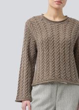 Loose knit with wide sleeves in cable knit. KurtisMD round neckline and rolled edges.