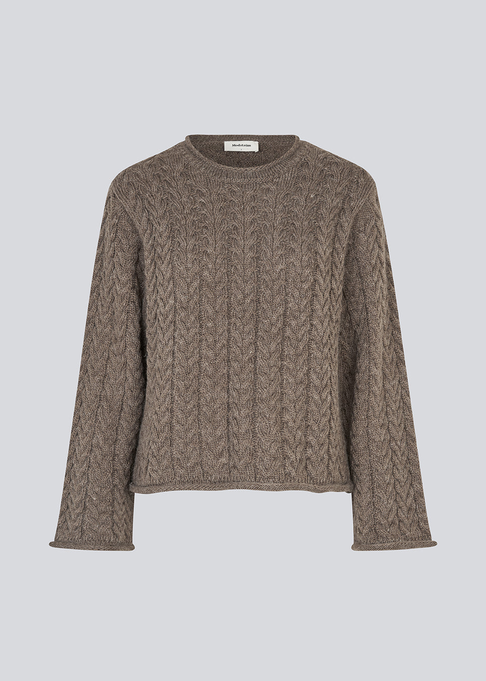 Loose knit with wide sleeves in cable knit. KurtisMD round neckline and rolled edges.