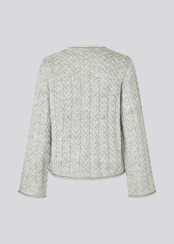 Loose grey wool knit with wide sleeves in cable knit. KurtisMD o-neck has a round neckline and rolled edges.