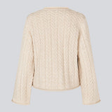 Loose creme knit with wide sleeves in cable knit. KurtisMD o-neck has a round neckline and rolled edges.