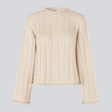 Loose creme knit with wide sleeves in cable knit. KurtisMD o-neck has a round neckline and rolled edges.